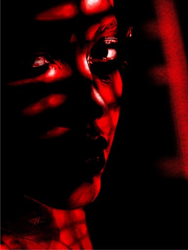 Close-up portrait with shadows and red light creating a dramatic effect.